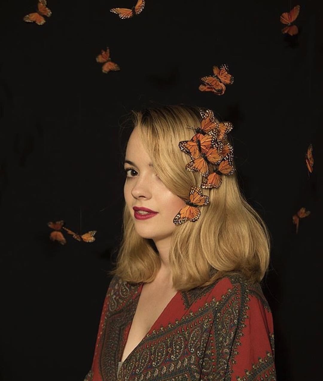 Portrait of a woman surrounded by monarch butterflies