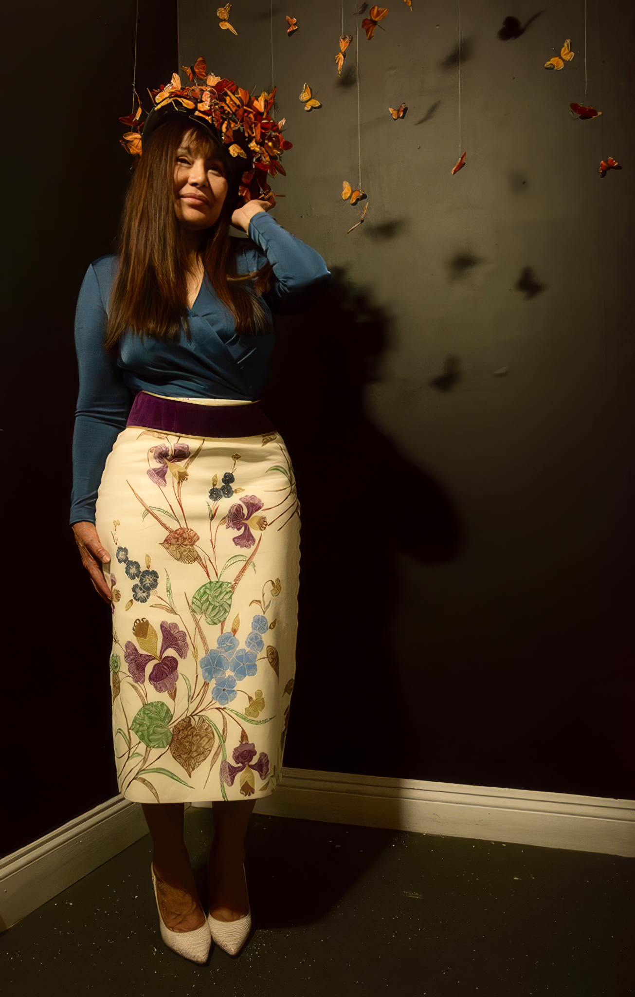 Olivia Barrionuevo standing among suspended monarch butterflies